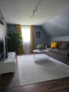 a living room with a couch and a table at Hyllstofta lägenhet in Klippan