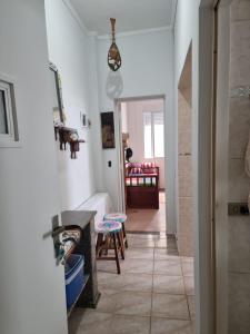 a room with a hallway with a table and a chair at Apartamento - kitnet in Guarujá
