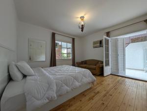 a white bedroom with a bed and a window at Villa Maadi 35 -R 101- Terrace View Room in Cairo +23 photos