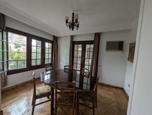 a dining room with a glass table and chairs at Villa Maadi 35 -R 101- Terrace View Room in Cairo