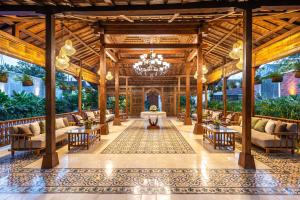 a lobby of a resort with couches and a chandelier at Kalynda Boutique Villa in Kejayan