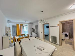 a room with a bed and a kitchen with a table at Alezzi Beach Resort - Sea View Suite in Mamaia Nord