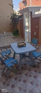 a blue picnic table and chairs on a patio at Belle maison in Chott Meriem