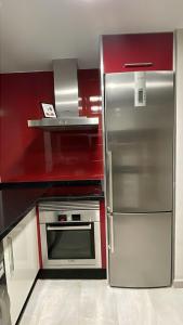 a kitchen with a stainless steel refrigerator and a microwave at Cala Serena in Los Alcázares