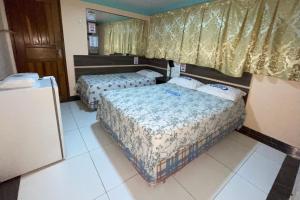 Postel nebo postele na pokoji v ubytování Hotel Opção