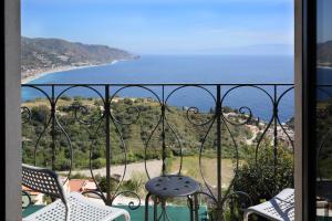 a balcony with a view of the ocean at Villa Astoria in Taormina