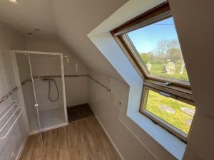 an attic bathroom with a shower and a window at Menhirs et Moutons Ouessant in Plouëc-du-Trieux +21 photos