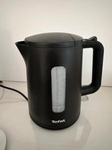 a black coffee pot with a remote control in it at la bussola gallipoli in Gallipoli