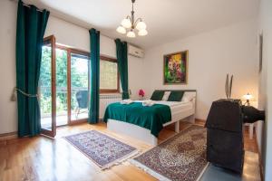 a bedroom with a bed and a large window at 6BDR Home in Nature in Sarajevo +33 photos