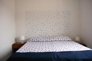 a bedroom with a bed with a blue and white comforter at Meraviglia in riva al mare in Belmonte Calabro