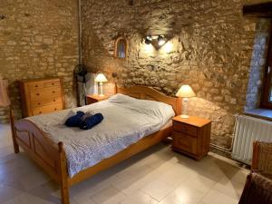 a bedroom with a bed with two night stands and two lamps at Lovely family house in the middle of nature in Saint-Marcel-du-Périgord