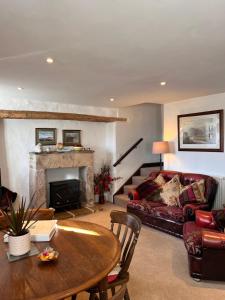 a living room with a couch and a table at Riding house Farm Cottages in Castleton
