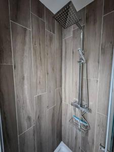 a bathroom with a shower with a wooden wall at Studio Lumineux Proche Centre et Port in Port-Vendres