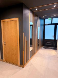 a hallway with a door and a room with windows at Studio Lumineux Proche Centre et Port in Port-Vendres