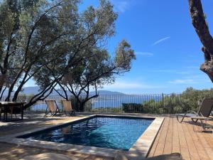 a swimming pool with a view of the water at Résidence Licciola in Propriano