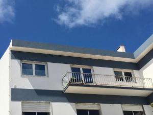 a white building with a balcony on top of it at CALIFORNIA dream in Peniche