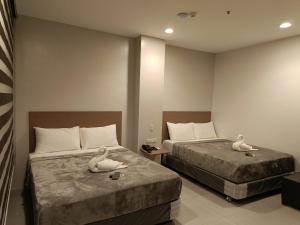 Postel nebo postele na pokoji v ubytování Citi Hotel Uno