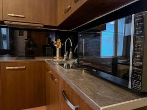 a kitchen with a microwave and a counter top at Studio Lumineux Proche Centre et Port in Port-Vendres +10 photos