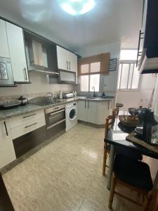 a kitchen with a sink and a dishwasher at Almeria playa Zapillo in Almería