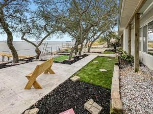a wooden bench sitting outside of a house at Baywatch Paradice Bayfront, private pier, Sleeps 8 Fenced Dog Area 8 m to beach in Gulf Shores