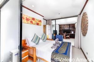 a bedroom with a bed and a living room at Patong Tower Amazing Sea View 12 by PHR in Patong Beach