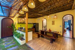 a kitchen and living room with a table and a counter at Dan Linh Homestay in An Bang