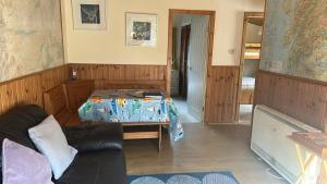 a living room with a bed and a couch at Spean Bridge Chalet in Spean Bridge