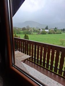 a view from a window of a field at House Mara in Korenica