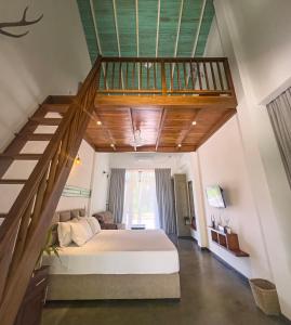 a bedroom with a large bed and a staircase at Green Hideaway - Villa with Private Pool, 8 mins to Galle Fort in Galle