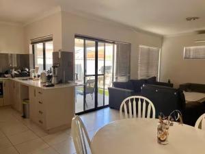 a kitchen and living room with a table and chairs at Rooms in Quiet House in Bedford in Perth