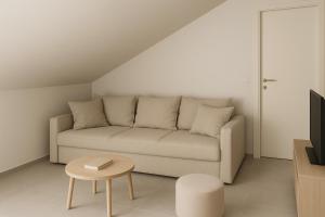 a living room with a couch and a table at Apartmaji ŽIVA in Blato