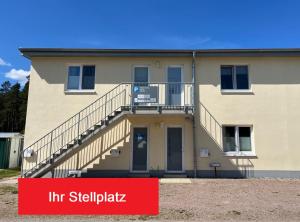 a building with stairs and a sign in front of it at Pusteblume in Graal-Müritz
