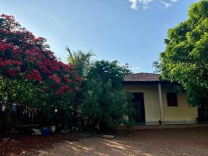 a house with trees and flowers in front of it at Toca da Onça in Coronel José Diaz