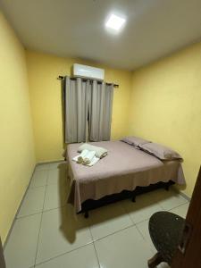 a small room with a bed with a window at Toca da Onça in Coronel José Diaz