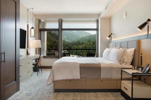 a bedroom with a bed and a desk and a window at Westin Resort 721 in Avon +37 photos