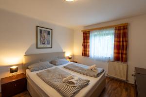 a bedroom with two beds with towels on them at Studio Nonntal in Salzburg