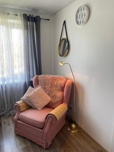 Ein Stuhl mit einer Lampe steht in einem Wohnzimmer. in der Unterkunft VPhouseVP in Sillamäe + 8 Fotos