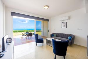 a living room with a couch and a table at Villa Dimitra in Kato Yialia +22 photos