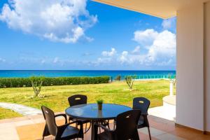 a table and chairs on a patio with a view of the ocean at Villa Dimitra in Kato Yialia