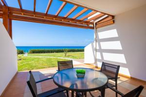 a dining room with a glass table and chairs at Villa Hera in Nea Dimmata