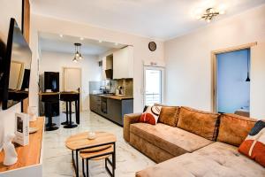 a living room with a couch and a kitchen at Up and down apartments in Mytilene