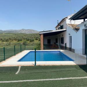 een zwembad voor een huis bij Cortijo Bachiller Alora 18 personas Fiestas tranquilas in Alora