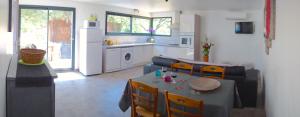 a kitchen and living room with a table and chairs at Le Clos Saint Elme in Collioure