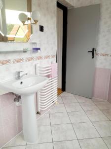 a bathroom with a white sink and a mirror at Pokoje gościnne Rafa in Łeba +34 photos