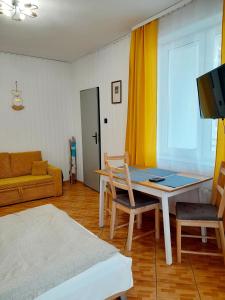 a living room with a table and a couch at Pokoje gościnne Rafa in Łeba