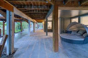 a covered porch with a bed in a building at Riverfront Suite in Washougal