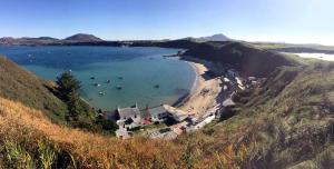 a view of a beach with boats in the water at Yr Hen Felin - The Old Mill B&B in Morfa Nefyn