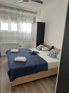a bedroom with a large bed with two towels on it at Apartman Sandra in Podstrana