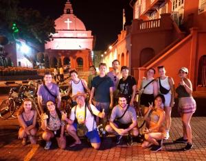 a group of people posing for a picture on a street at Ringo's Foyer in Melaka