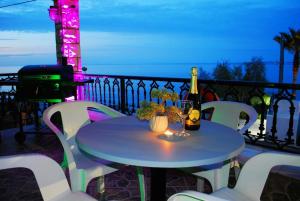 a table with a bottle of wine and a glass at Casa Di Marinero Apartments in Argasi +34 photos
